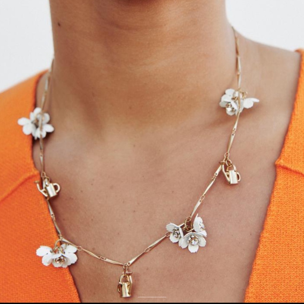 ZARA — Metal necklace with flower and watering can charms.